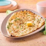 Garlic Naan: Soft, fluffy Indian bread infused with garlic and butter, perfect for pairing with any curry or gravy.