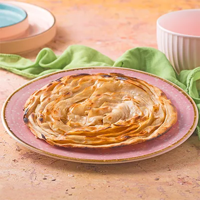 Flaky, multi-layered Indian bread, perfectly crisp on the outside and soft on the inside, ideal for pairing with any curry.