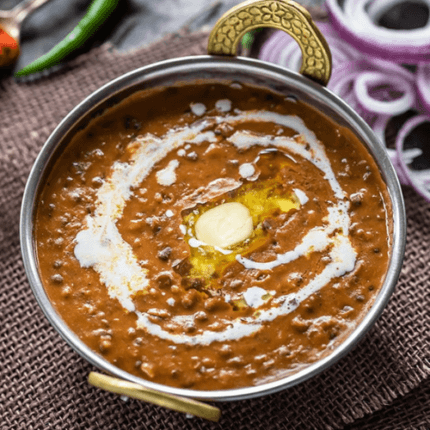 Creamy and rich black lentils slow-cooked with butter, cream, and aromatic spices for a classic Indian delicacy.