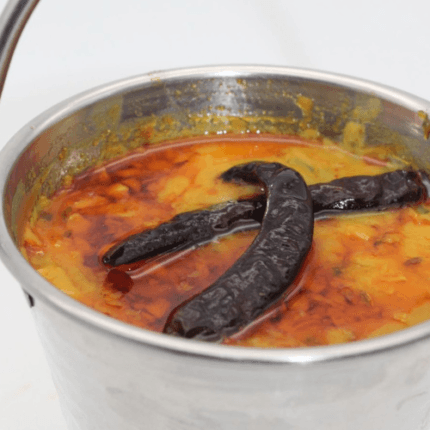 Aromatic yellow lentils tempered with ghee, garlic, and flavorful spices for a classic Indian comfort food.