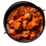 Juicy marinated chicken pieces grilled and simmered in a rich, spiced tomato-based gravy.