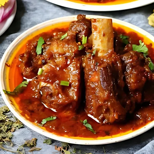 A fiery and flavorful mutton curry cooked with red chilies, yogurt, and traditional Rajasthani spices.