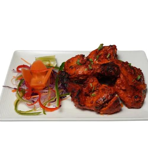 Juicy chicken marinated in yogurt and spices, grilled to perfection in a traditional tandoor for a smoky and flavorful taste.