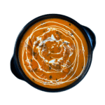 Butter Chicken: Creamy tomato-based curry with tender chicken pieces, garnished with fresh cream